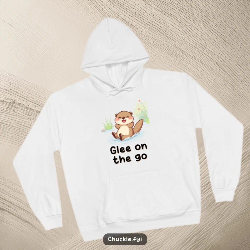 Funny Hoodie: A joyful otter character gleefully slides down a riverbank, radiating fun and happiness.