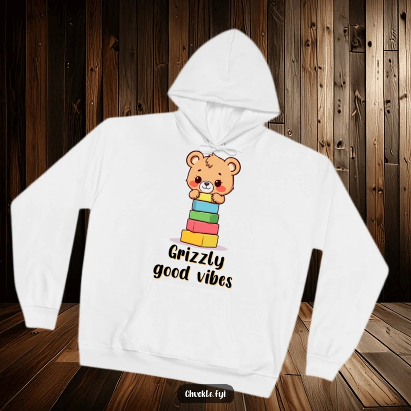 Funny bear cub hoodie featuring a brave little bear cub focused on balancing a teetering tower of colorful blocks, very cute.