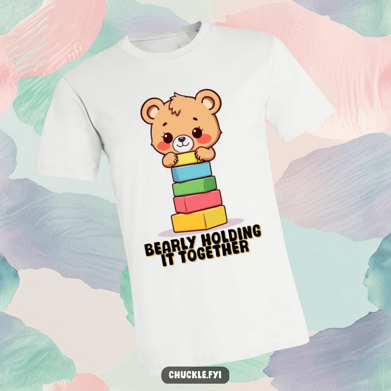 Funny bear cub t-shirt illustrating a brave little cub precariously balancing a stack of colorful blocks, showing effort and humor.